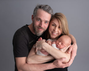 This is a newborn photography image of a newborn Family photo with grey backdrop