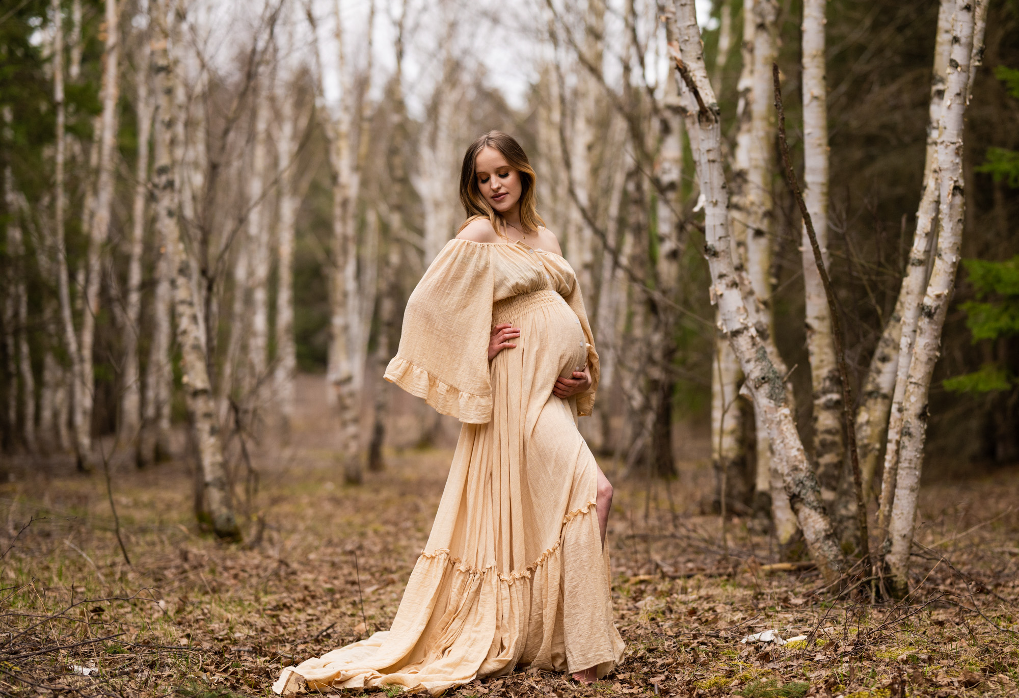 mom to be in champagne maternity gown in the woods Ottawa Maternity Stores